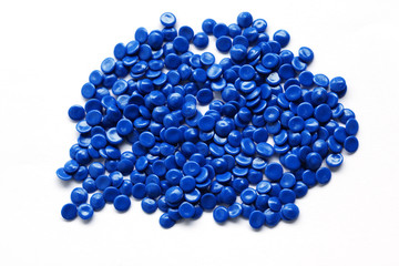 close up of blue industrial plastic pellet on white background