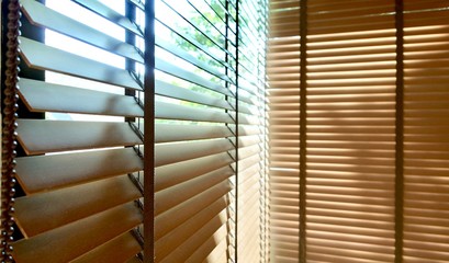 Evening sun light outside and wooden window blinds, sunshine and shadow on window blind, decorative interior home concept
