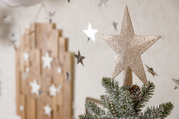 The Scandinavian style Christmas or New Year background: Christmas star, pink glass balls and toys, wooden decoration, silver twinkling stars