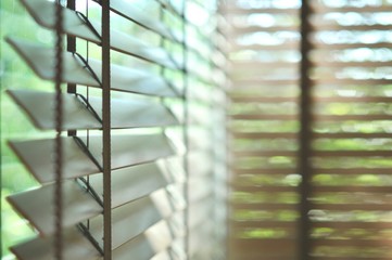 Evening sun light outside and wooden window blinds, sunshine and shadow on window blind, decorative interior home concept