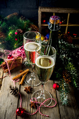Two glasses of champagne with Christmas decoration on wooden background, Happy New Year and Xmas Celebration. Copy space