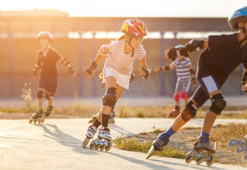 A girl training inline skating with other children