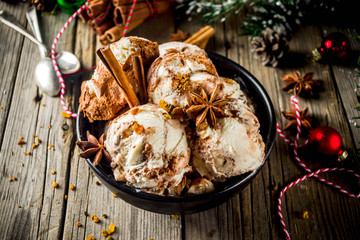 Christmas dessert, Homemade Eggnog or Gingerbread Ice Cream with Cinnamon, anise, spices, old wooden background with xmas decorations, copy space