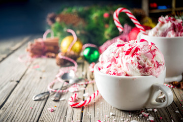 Christmas dessert, Homemade Peppermint Candy Cane Ice Cream in two cups, old wooden background with...