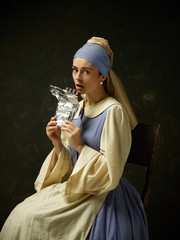 Medieval woman in historical costume wearing corset dress and bonnet. Beautiful peasant girl...
