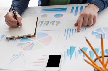 stock market chart and finger pointing on tablet in office