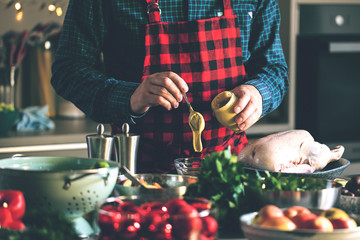 Man preparing delicious and healthy food in the home kitchen for christmas (Christmas Duck or Goose)