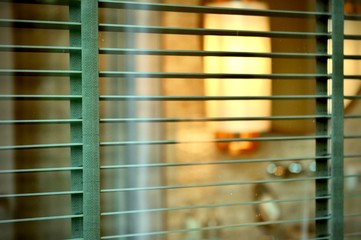 Evening sun light outside window blinds, sunshine and shadow on window blind and Granite tile wall, wooden blinds decorative interior home concept
