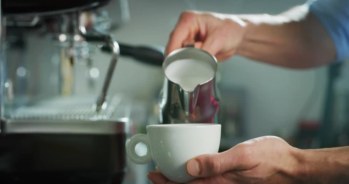 Tipi di file: Tutto (415) Vai a pagina |12345Avanti Portrait of a barman while making a cappuccino next to the coffee machine in a typical italian bar. 
