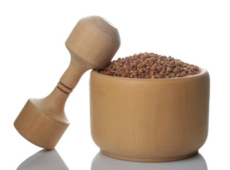 Buckwheat in a wooden mortar on a white isolated background. porridge. healthy food. cereals.