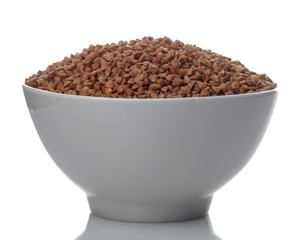 Buckwheat groats in a white bowl on a white isolated background. porridge. healthy food. cereals.