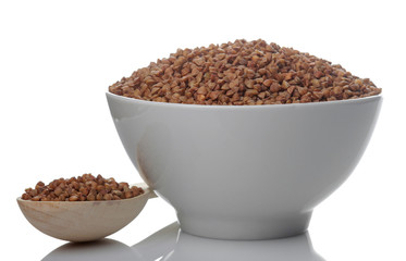 Buckwheat groats in a white bowl with a spoon on a white isolated background. porridge. healthy food. cereals.