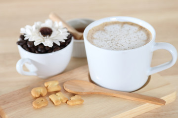 Hot coffee and biscuit on wooden table