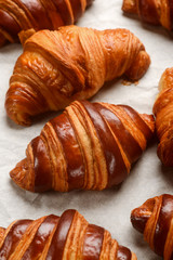 Freshly baked croissants on parchment
