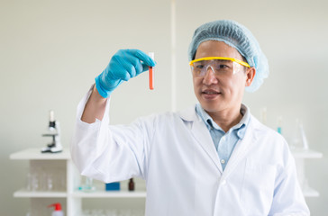 Scientist hands holding medical chemicals sample in test tube with blood sample