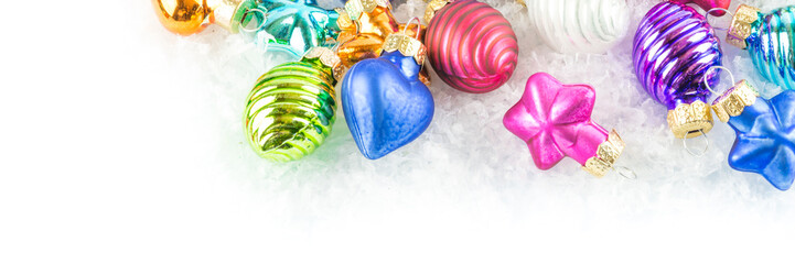 A lot of colourful Christmas balls in the snow, banner