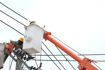 NONTHABURI, THAILAND - APRIL 29, 2017: Electrician are installing high powered electric cables to cope with the increasing power usage of people in the community
