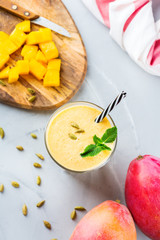 Mango lassi, indian drink, smoothie beverage with yogurt