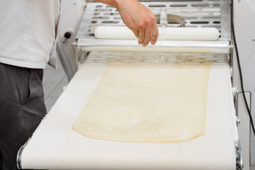 Baker making layered dough
