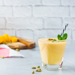 Mango lassi, indian drink, smoothie beverage with yogurt