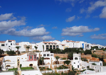 Panoramic cityscape view of white houses in ciutadella menorca against a blue sky