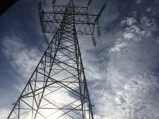 electricity pylon against blue sky