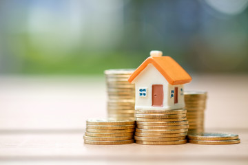 House model on heap of coins. Business and finance, Property investment and asset management, Fund,...