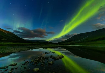 Türaufkleber aurora borealis in the night sky cut the mountains, reflected in the water. © Igor Dmitriev