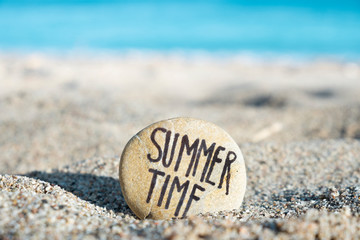 text summer time in a stone on the beach