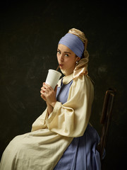 Medieval Woman in Historical Costume Wearing Corset Dress and Bonnet. Beautiful peasant girl...