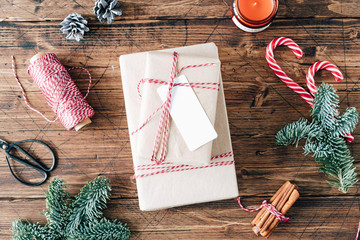 Christmas gift box, presents, dark background with holiday decoration, christmas candy, red and...