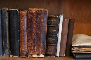 Antique books on bookshelf. Old leather bound vintage books