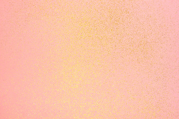 Beautiful light pink background with golden glitter. Holiday decoration concept.