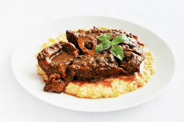 braised with wine and vegetables cross-cut beef shank garnished with risotto
