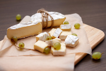 white mold cheese and grapes on the table