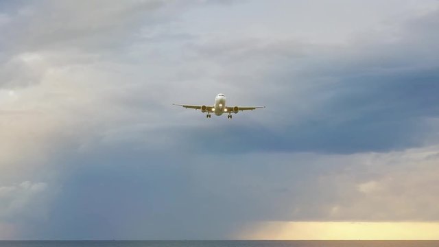 Close up of aeroplane flying in rain cloudy sky,low angle view.
Commercial plane flying over andaman sea heading to phuket international airport close to mai khao beach at sunset,hd slow motion.
