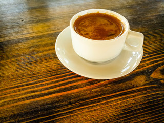 a Cup of natural black coffee on a wooden table in a seaside cafe