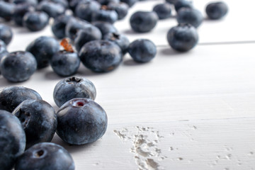 group of blueberries over a white wood table