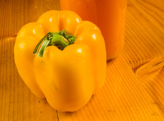 fresh yellow paprika, bell pepper and a bottle of pumpkin juice
