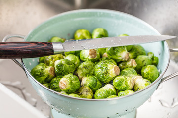 washing raw Brussels sprouts in kitchen sink