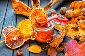Apple-pumpkin jam with orange decorated with autumn leaves.Autumn season