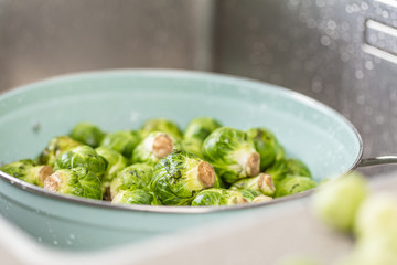 washing raw Brussels sprouts in kitchen sink