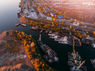 Port industrial barge ships cargo transportation, cranes on pontoons. © Parilov