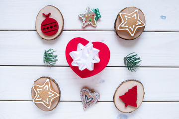 Gingerbread cookies, sweets, gifts and beautiful Christmas decorations on the white wooden background. Flat lay, top view, space for a text. Close up.