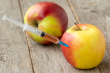 Syringe in apple