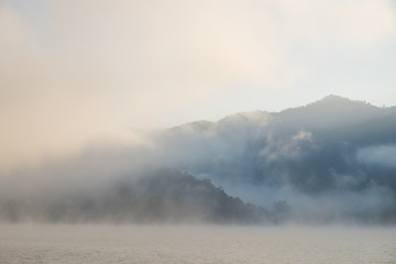 Fototapeta na wymiar The mist in the lake in the morning.