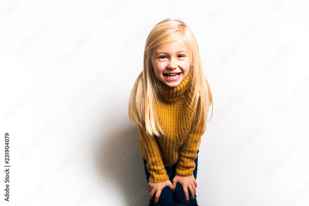 Wall mural A Cute girl 5 year old posing in studio