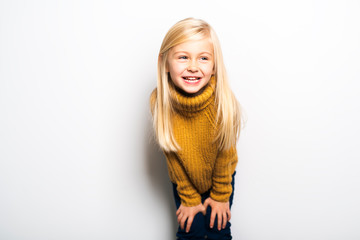 A Cute girl 5 year old posing in studio