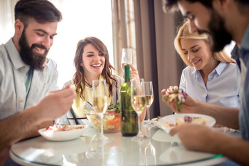 Friends having lunch together at home.