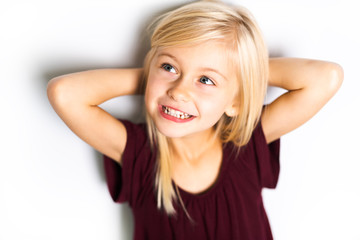 A Cute girl 5 year old posing in studio